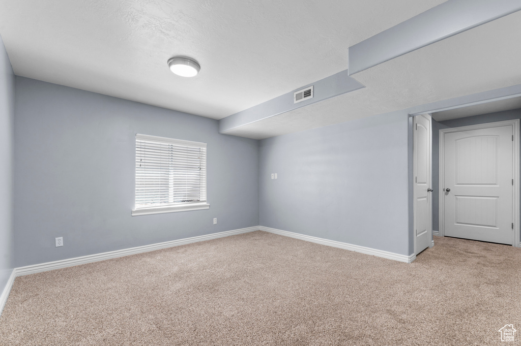 Carpeted empty room with baseboards