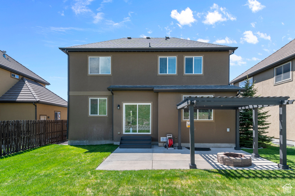 Rear view of house with an outdoor fire pit, a patio area, a pergola, and stucco siding