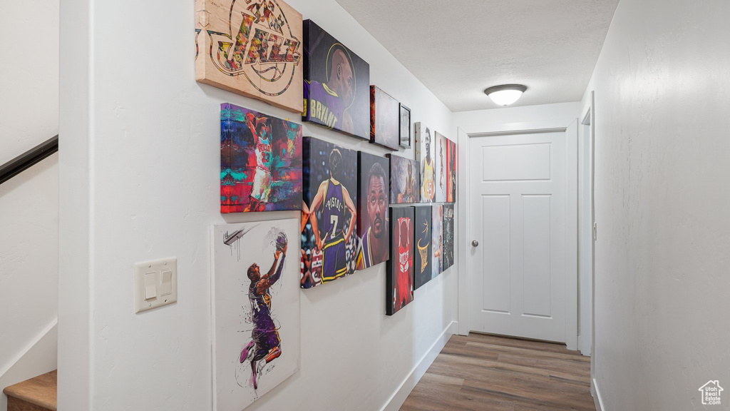 Corridor featuring wood finished floors and baseboards
