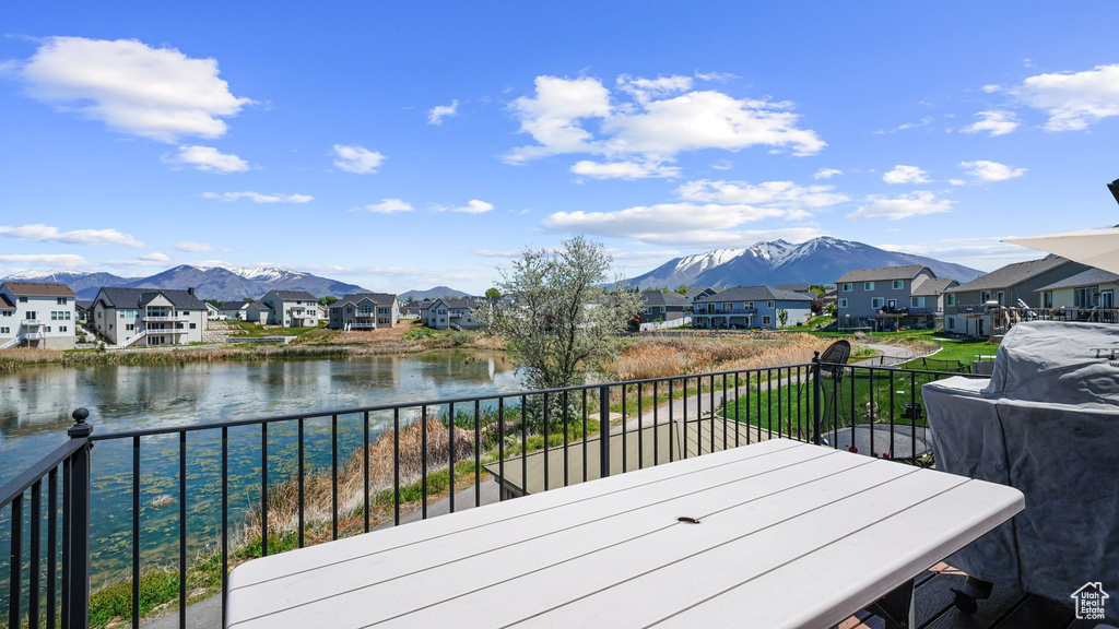 Deck featuring a residential view and a water and mountain view