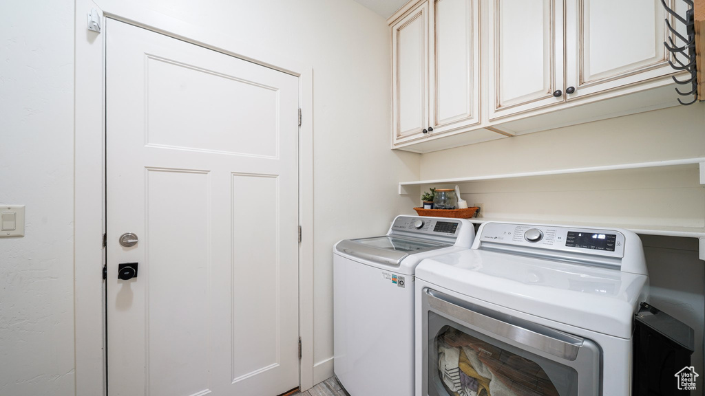 Laundry area featuring washer and dryer and cabinet space
