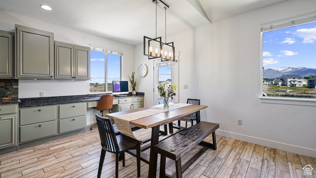 Dining area featuring light wood-type flooring, baseboards, a chandelier, and recessed lighting