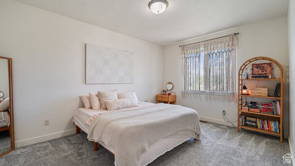 Carpeted bedroom featuring baseboards