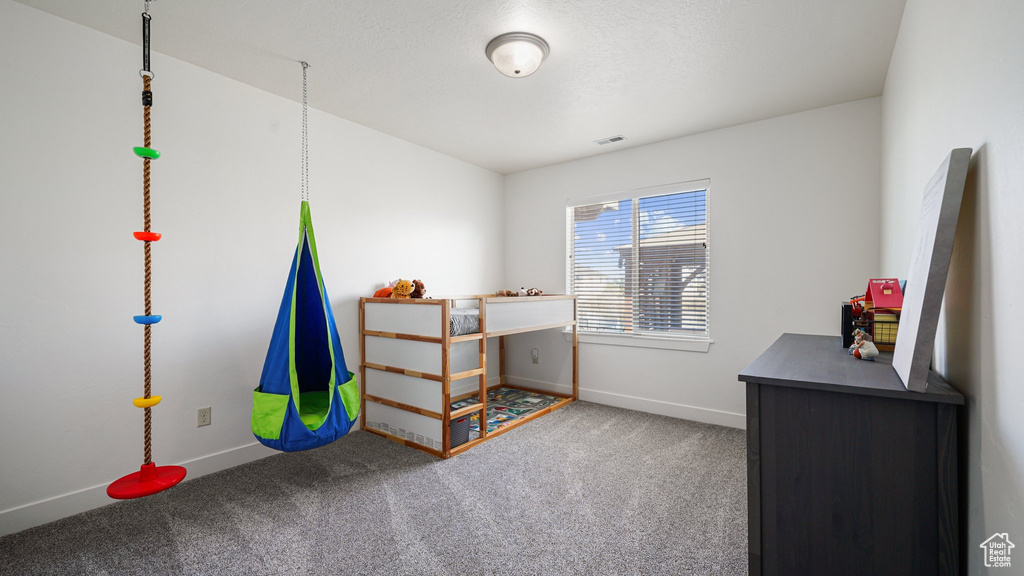 Carpeted bedroom with baseboards