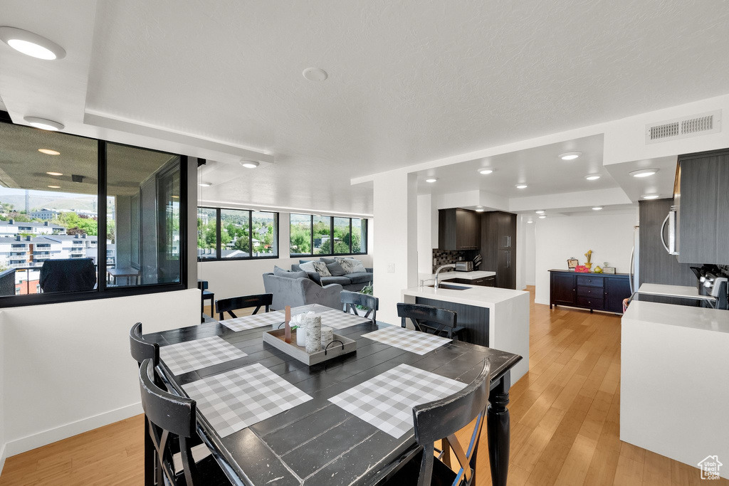 Dining area featuring light wood-style flooring and recessed lighting
