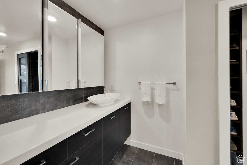 Bathroom featuring vanity and baseboards