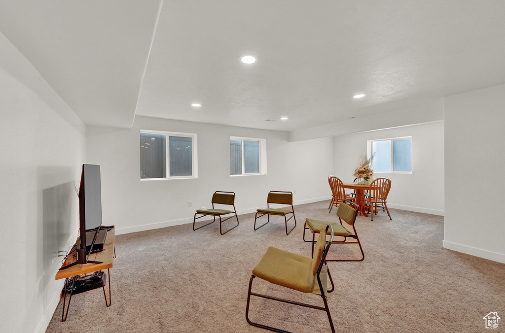 Living area featuring light colored carpet, recessed lighting, and baseboards