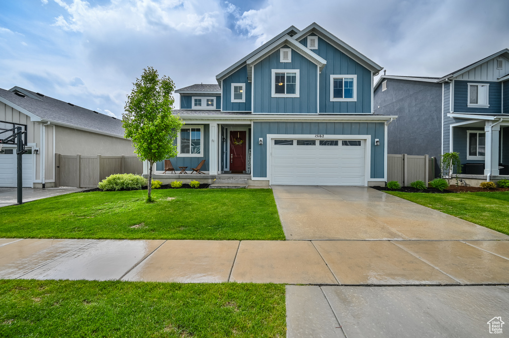 Traditional-style house featuring board and batten siding, concrete driveway, an attached garage, and a porch