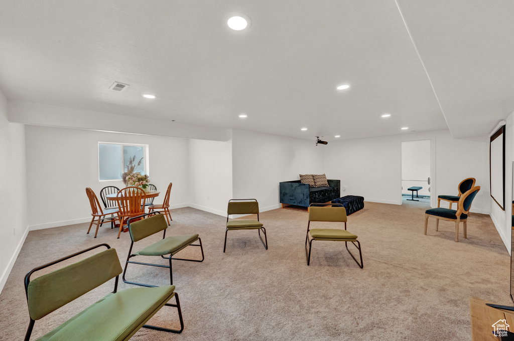 Living area featuring light carpet, recessed lighting, and baseboards