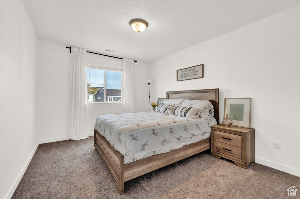 Carpeted bedroom with baseboards