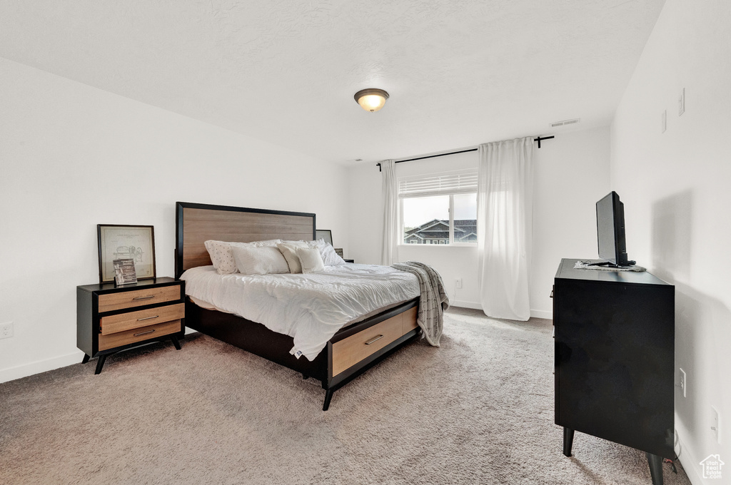 Carpeted bedroom featuring baseboards