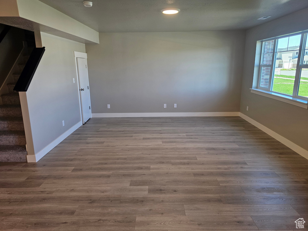 Unfurnished room with stairs, baseboards, recessed lighting, dark wood-style flooring, and a smoke detector