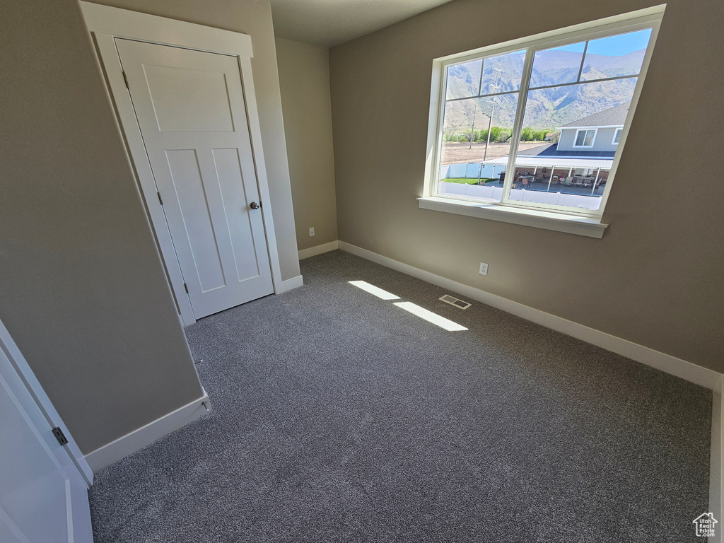 Unfurnished bedroom featuring baseboards and carpet floors