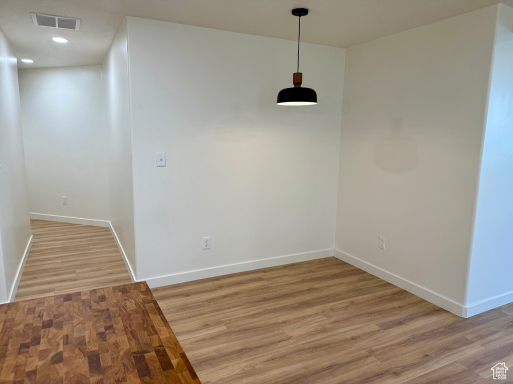 Unfurnished dining area with baseboards, light wood-style flooring, and recessed lighting