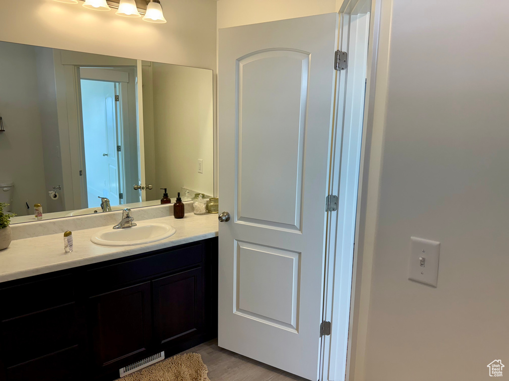 Bathroom with vanity and wood finished floors