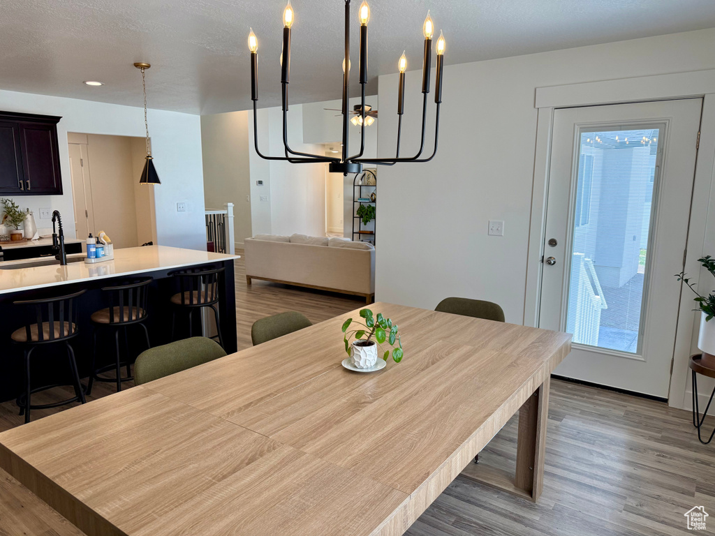 Dining area featuring light wood-style flooring and a chandelier
