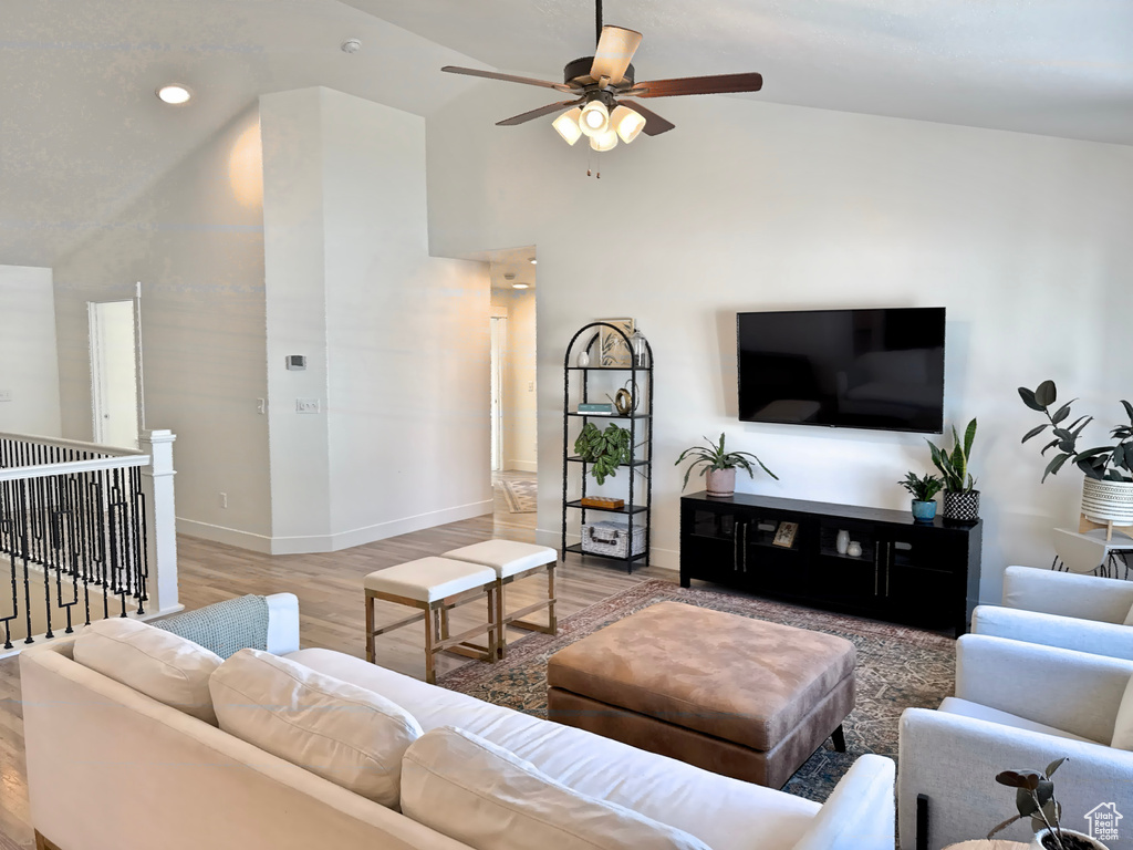 Living area featuring ceiling fan, light wood-style flooring, baseboards, recessed lighting, and high vaulted ceiling