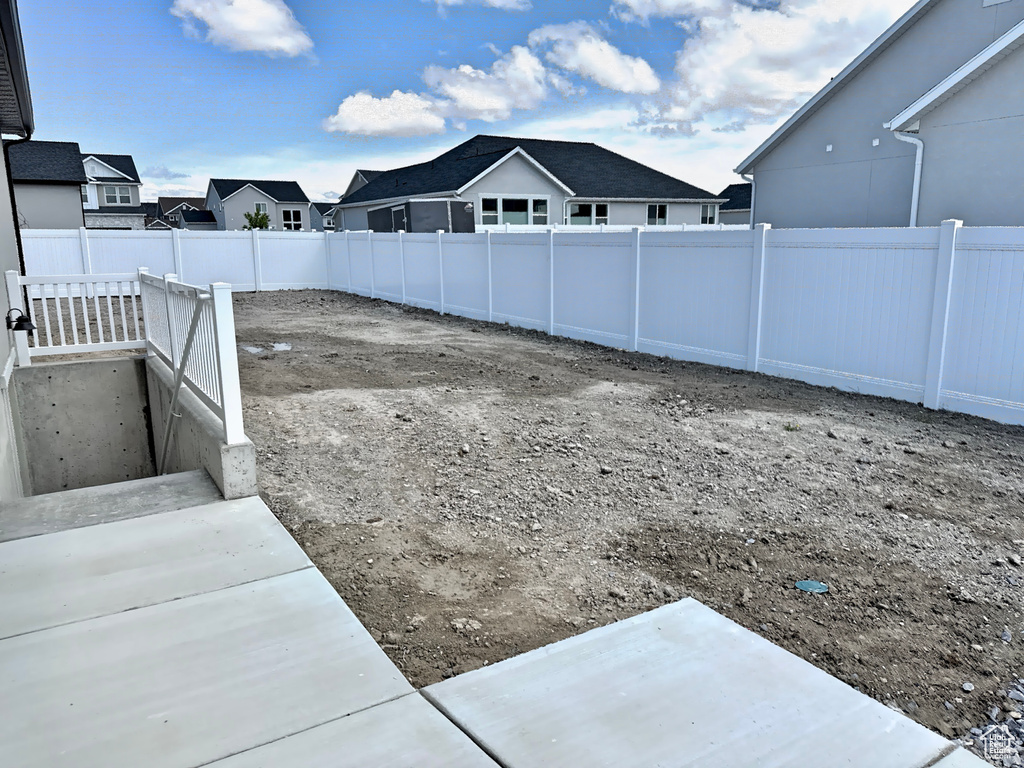 Fenced backyard with a residential view