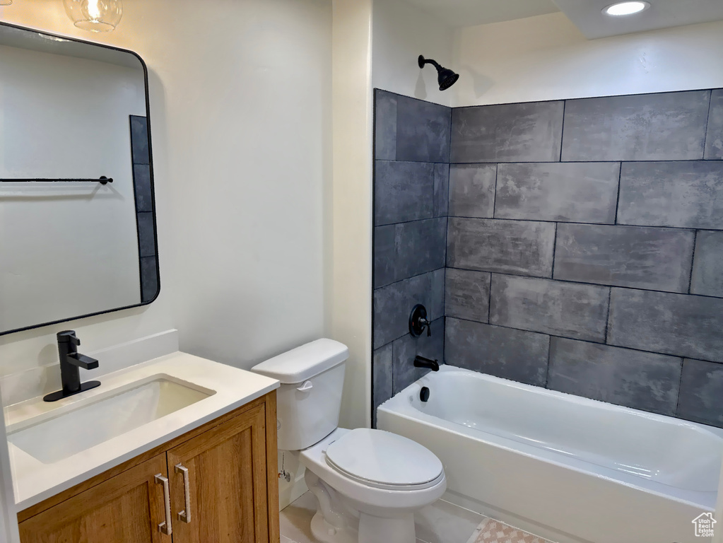 Bathroom with toilet, vanity, and shower / bathtub combination