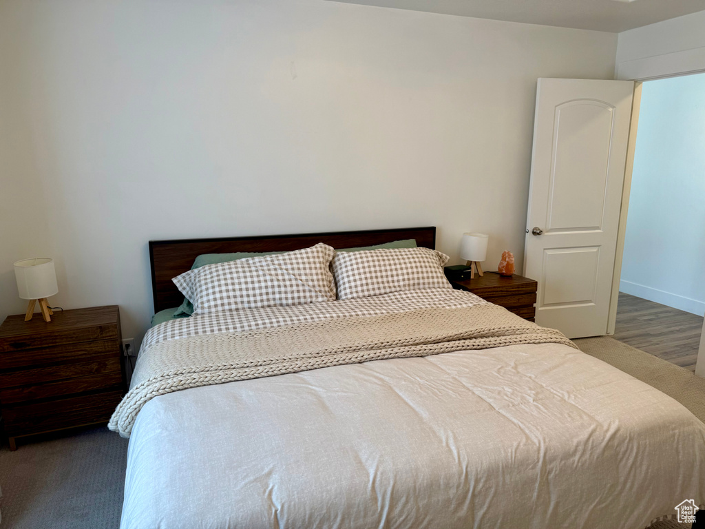 Bedroom with wood finished floors and baseboards