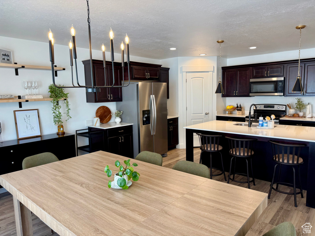 Dining area featuring light wood finished floors and recessed lighting