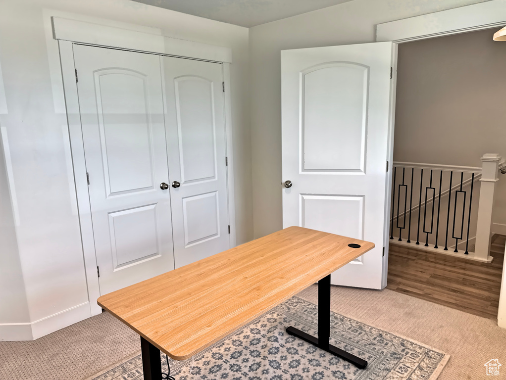 Home office featuring carpet floors and baseboards