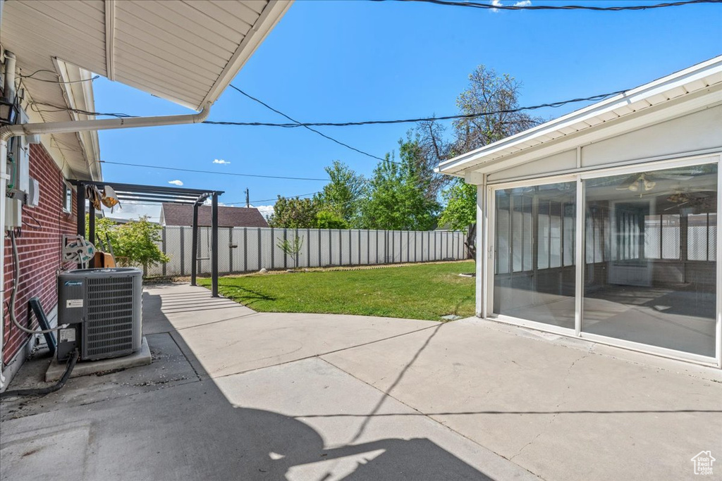 View of patio with central air condition unit and a sunroom
