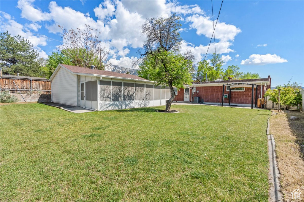 View of yard featuring a sunroom