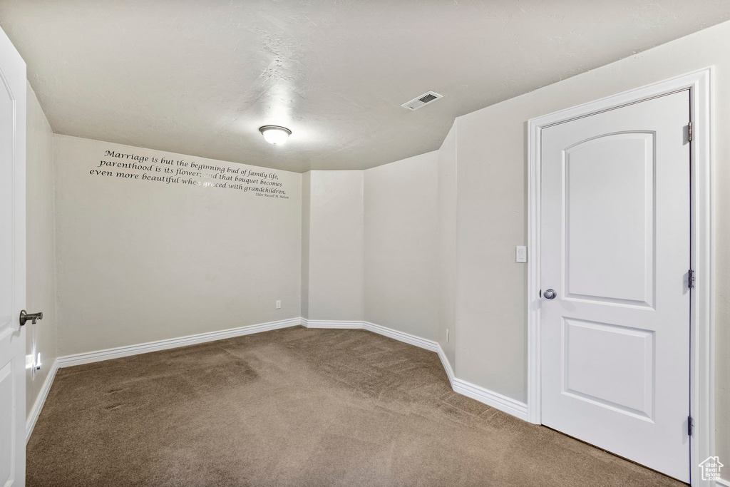 Spare room with baseboards, carpet, and visible vents