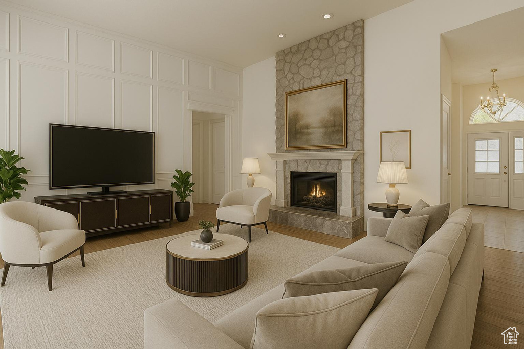 Living room featuring a chandelier, wood finished floors, a fireplace, and high vaulted ceiling
