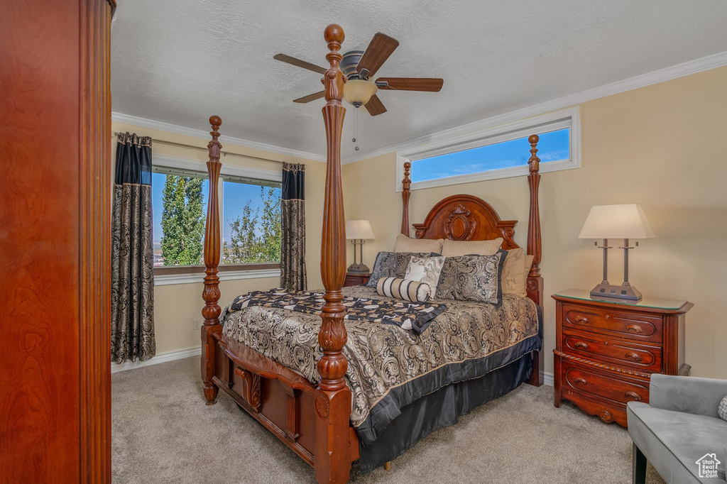 Bedroom featuring carpet, baseboards, ornamental molding, and ceiling fan