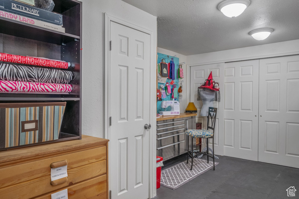 Bedroom with a textured ceiling and a closet