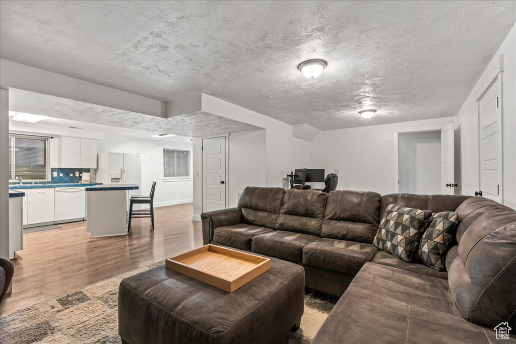 Living room featuring light wood-style flooring and baseboards