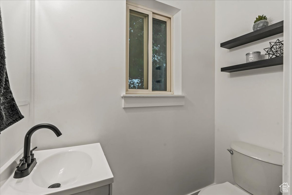 Half bathroom with toilet and vanity