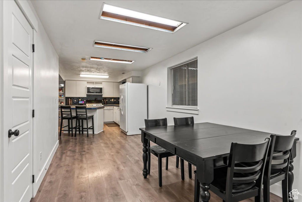 Dining area with light wood finished floors