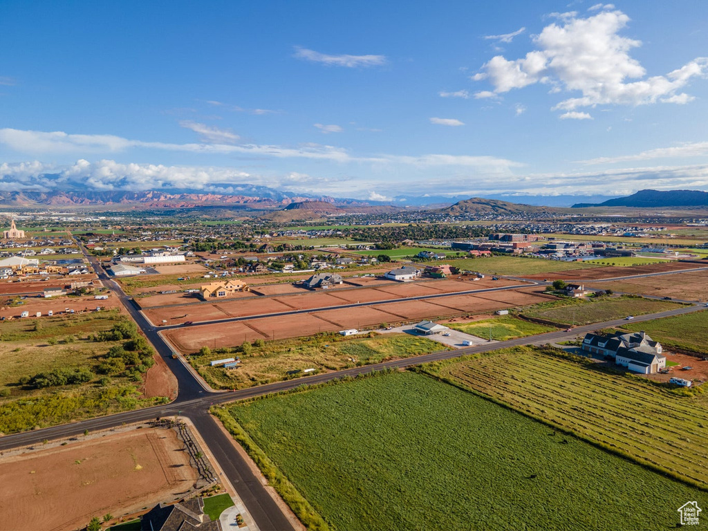 View of rural area with a mountain backdrop and farmland