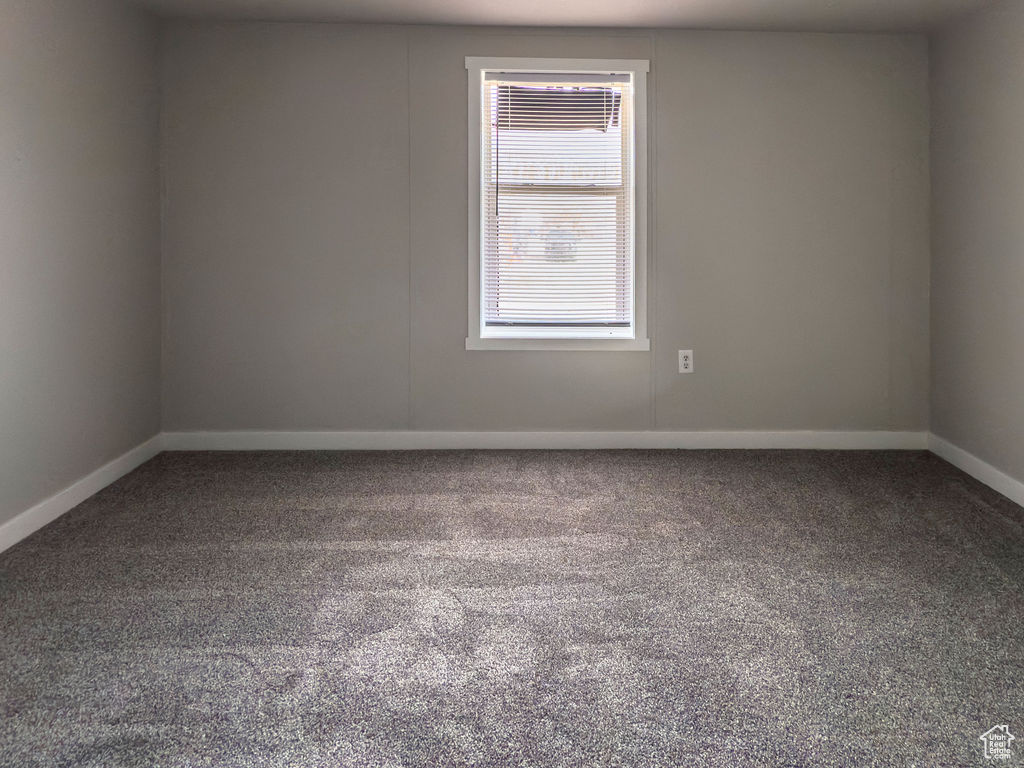 Empty room featuring carpet floors and baseboards