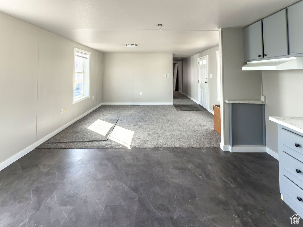 Unfurnished living room with baseboards
