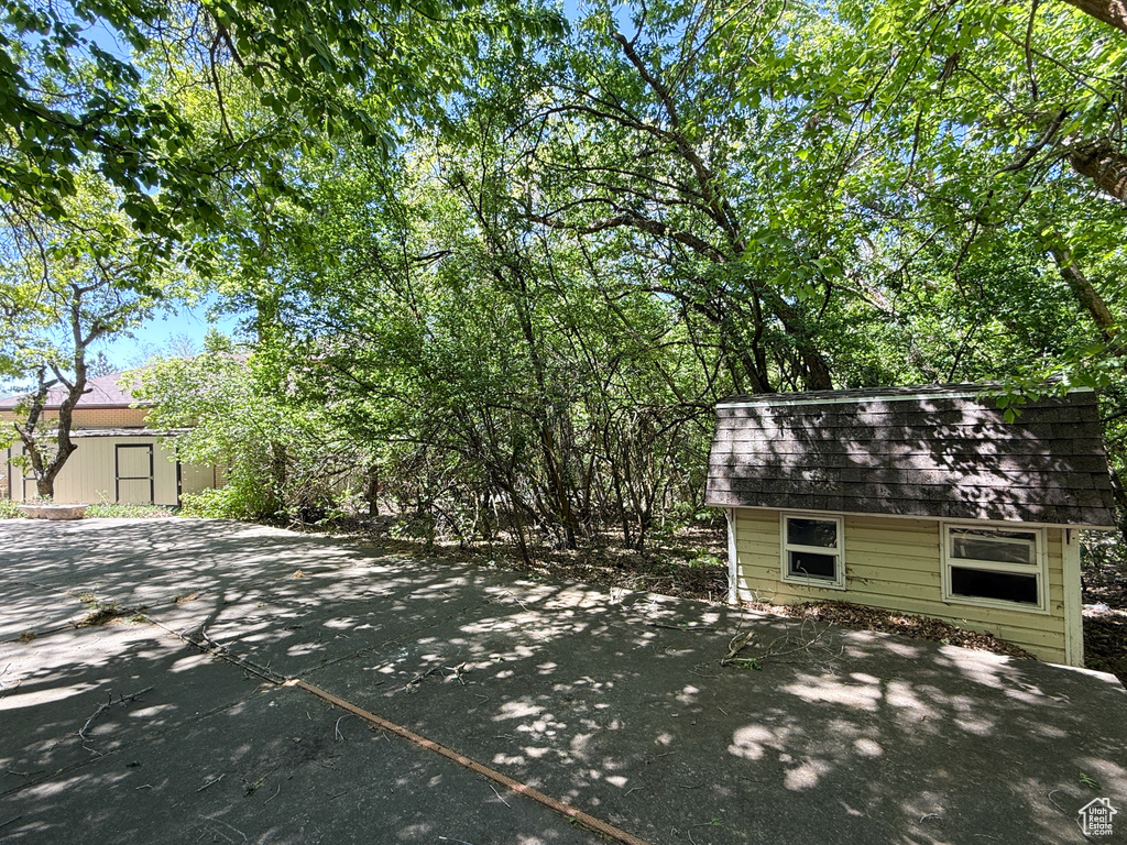 View of patio with an outbuilding and a storage unit