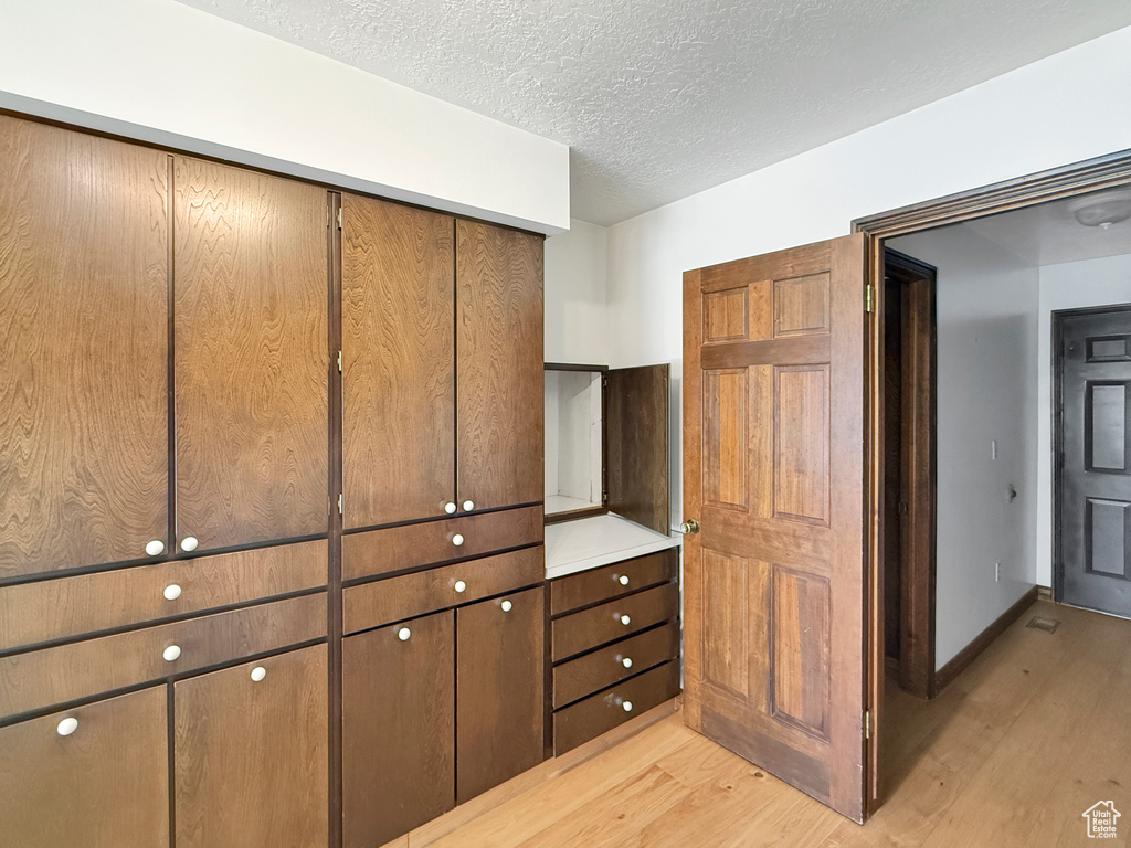 Interior space with wood finished floors and a textured ceiling