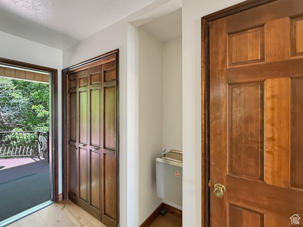 Foyer entrance featuring light wood-style flooring and baseboards