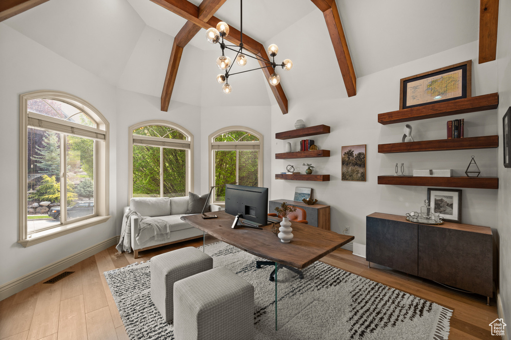 Office space featuring a chandelier, light wood-style flooring, beam ceiling, and high vaulted ceiling