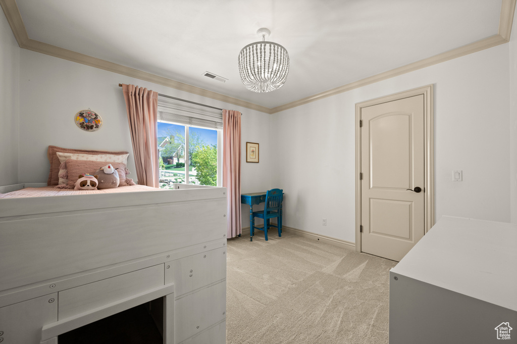 Bedroom with a chandelier, light carpet, ornamental molding, and baseboards