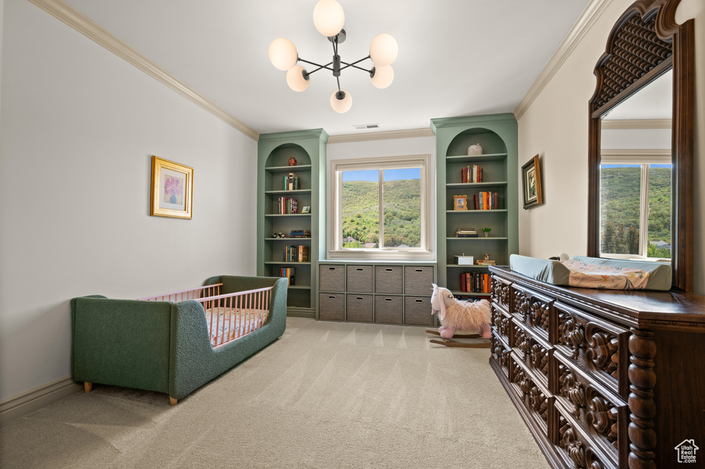 Living area featuring ornamental molding, carpet floors, a chandelier, and built in features