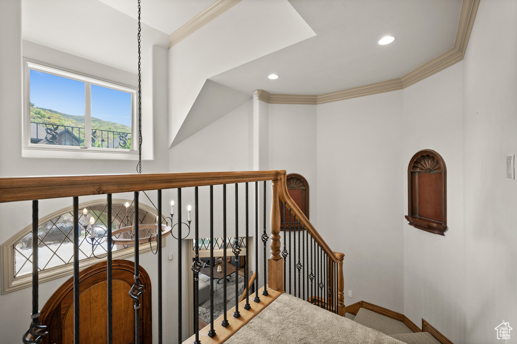 Staircase with recessed lighting, ornamental molding, and baseboards