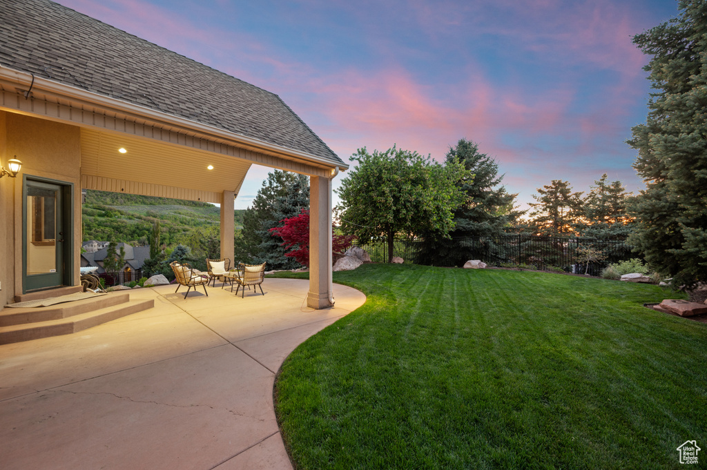 Yard at dusk with a patio area