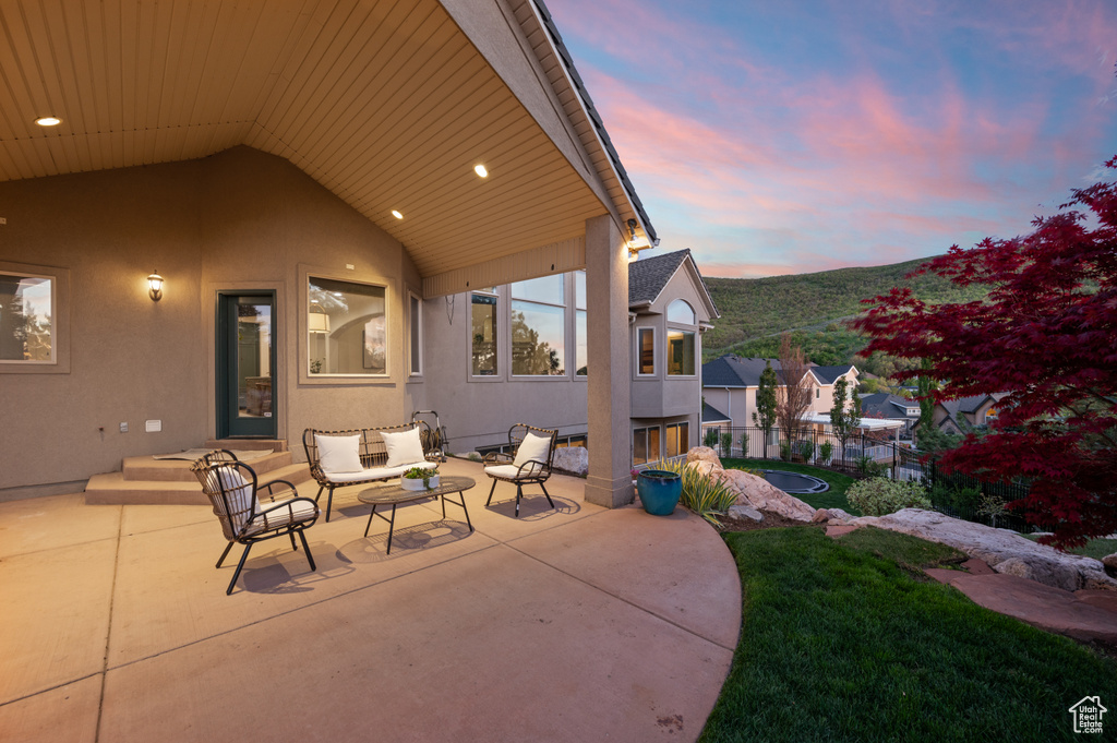View of patio with outdoor lounge area and fence