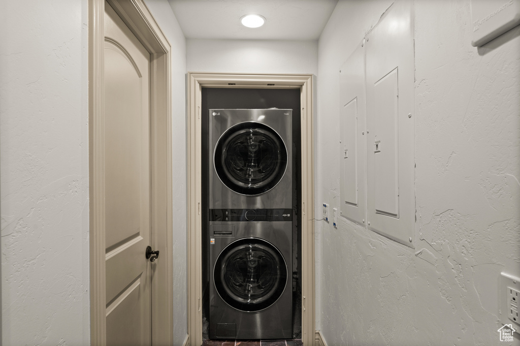 Laundry area with stacked washer and clothes dryer