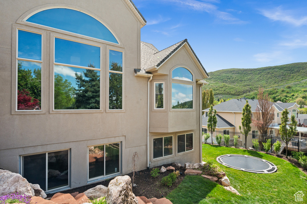 Rear view of property with stucco siding and a mountain view