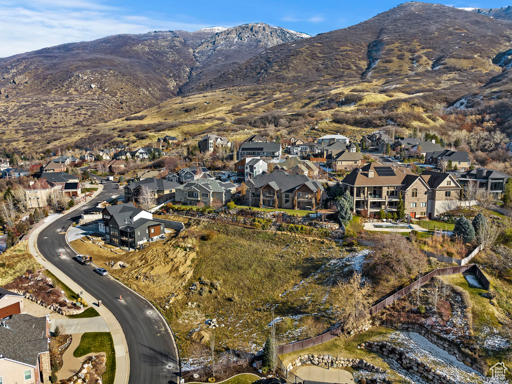 Aerial view of property's location with nearby suburban area and a mountain backdrop